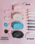 An example of the build-your-own crossbody. 4 treat pouches in the colors pastel pink, cream, pastel blue, and black (all with gold-toned clasps) line a flat service on the left side. In the middle, there are four crossbody bag pouches all the same colors as the matching treat pouches, then on the right side is 9 different varieties of straps which are as follows: sassy stripes (pastel rainbow), pastel pink, cream, cactus print, leopard print, blue desert floor, black, cow print, and dauschund print.