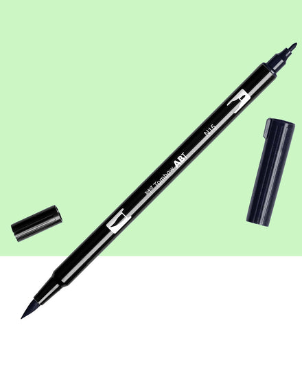 A black n15 dual sided tombow pen.  One side is a brush pen and the other side a normal thin marker pen.  The caps are off on both sides of the pen.  This pen sits on a light green and white background.