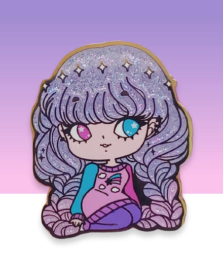 A girl with beautiful glittery and sparkly purple and pink gradient/ombre hair sitting with her legs bent.  She has two different colored eyes: one pink and one blue.  She is wearing a pink and blue and pullover sweater with a shooting star and clouds on it.  She also had purple leggings and she is looking off to the side.  This beautiful design is shown on a hard enamel lapel pin.