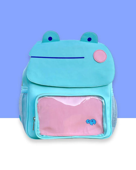 An extremely high quality blushing frog ita mint green back pack with dark blue details and pink cheeks. Comes with two inserts: one pink and the other dark blue for swappable pin displays. Extremely spacious inside and includes two side pockets.