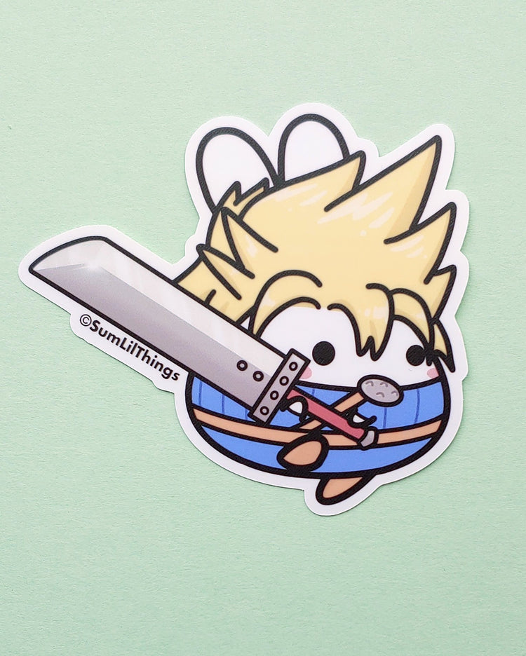 A cute chibi style kawaii bunny with yellow blond/blonde hair wearing a blue shirt and pants and a brown belt.  The bunny is cosplaying as Cloud from FFVII (Final Fantasy 7). He is holding a large sword.  This design is on a vinyl sticker and is designed by SumLilThings.