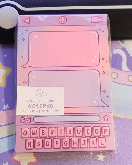 A pink, purple, and blue cotton candy ombred notepad featuring a keyboard, smilie, video camera, lens camera, and text conversation.  50 Sheets of non-sticky paper