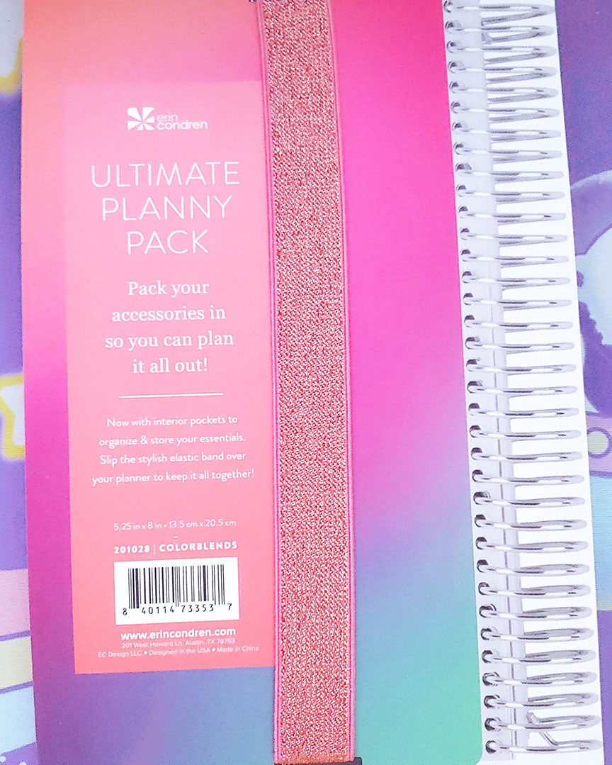 A coral, pink, purple, blue, and green ombre backing that reads "ultimate planny pack".  A gold and sparkly elastic band runs own the middle.  It also reads "pack your accessories in so you can plan it all out!"