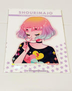 A young lady/adult/woman with yellow, pink, purple, and blue pastel ombre hair is blowing bubbles through a heart wand.  Her eyes are closed and she has blue and yellow eye shadow.  She is wearing a black choker and a black long sleeve shirt with yellow, pink, purple, and blue stars on the sleeves.  The shirt also has yellow, blue, and pink hearts on the front.  This digital art piece is print on a broken holographic vinyl sticker.  The sticker is attached to a white purple starred backing card.