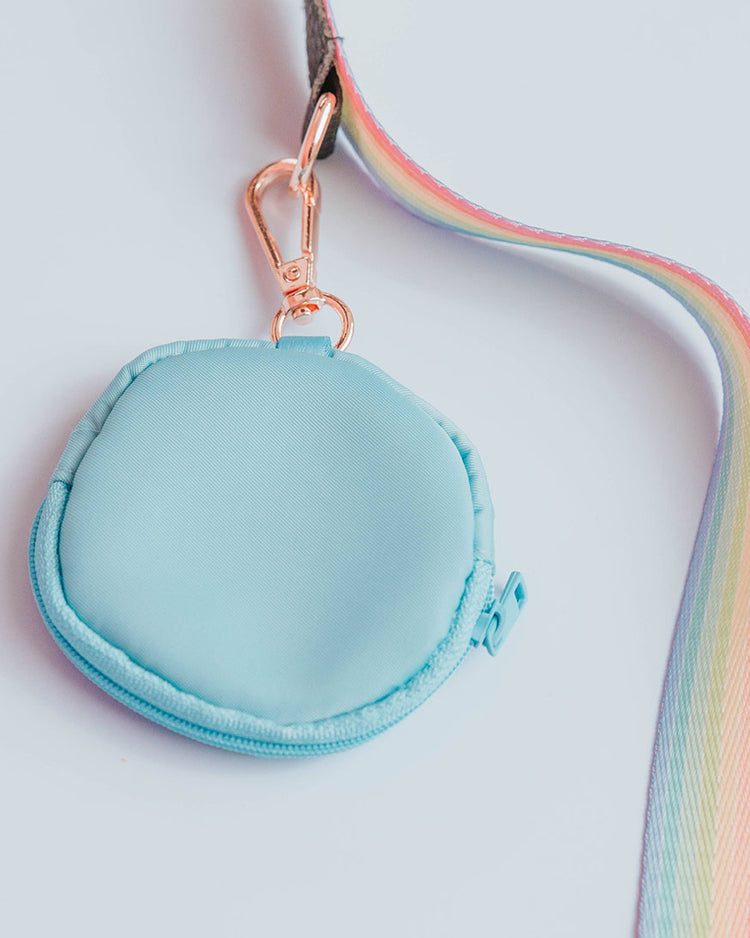 A blue circular treat pouch measuring about 3.45" (inches) with gold toned clasp attached to a sassy striped pastel rainbow strap to show example of the build-your-own style of the doggy crossbody set.