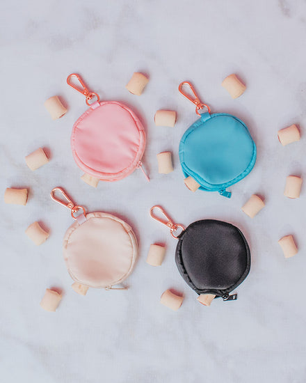 Four 3.45" (inches) circular treat bags in the shades: pastel blue, pastel pink, cream and black all with gold-toned clasps.