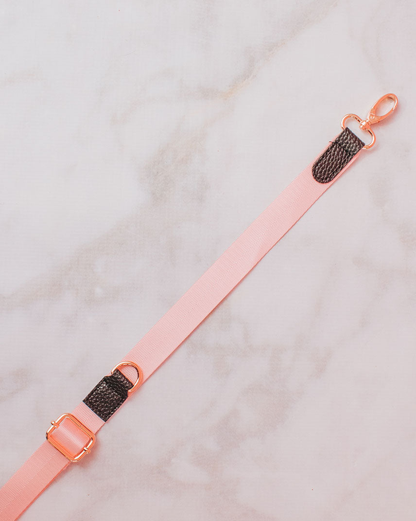 A pastel pink strap with black faux leather details and gold-toned clasp perfect for the build-your-own crossbody.