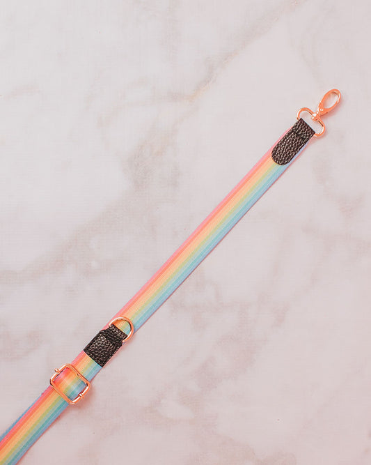 A pastel sassy stripes rainbow (pink, yellow, green, blue) strap with black faux leather details and gold-toned clasp perfect for the build-your-own crossbody.