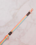 A pastel sassy stripes rainbow (pink, yellow, green, blue) strap with black faux leather details and gold-toned clasp perfect for the build-your-own crossbody.