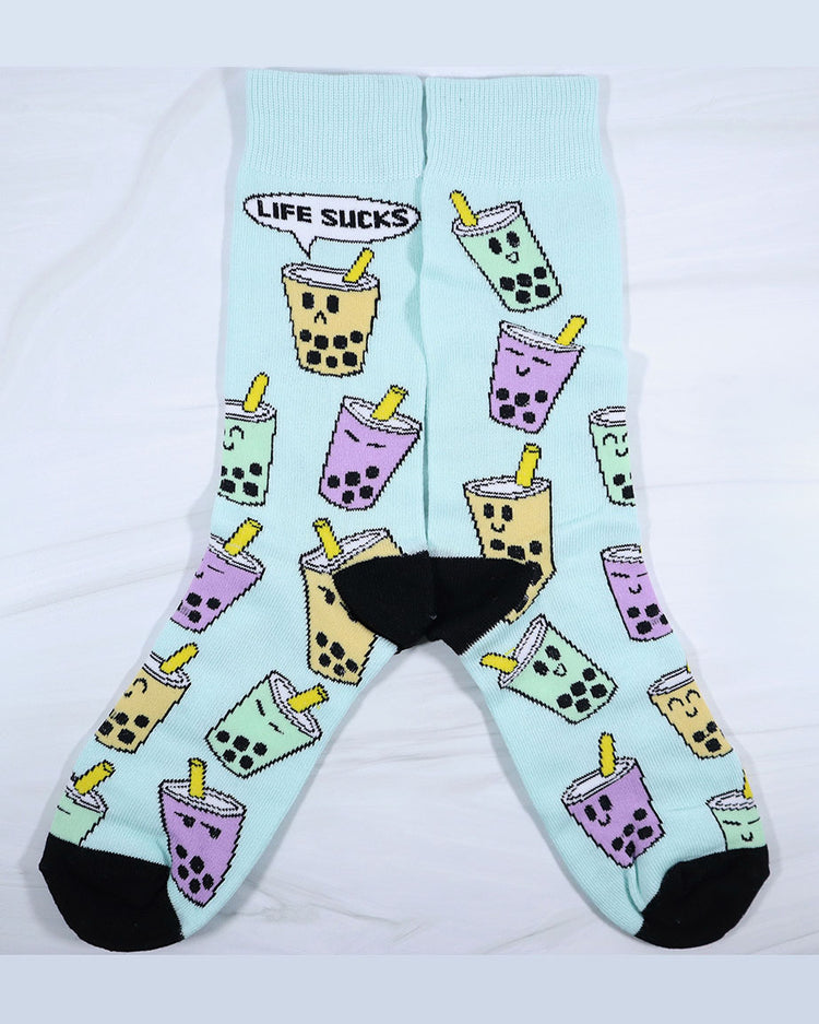 Yellow, purple, and green pastel kawaii boba socks. Reads "Life sucks." Happy and sad faces on mint colored socks with black toes and heels.