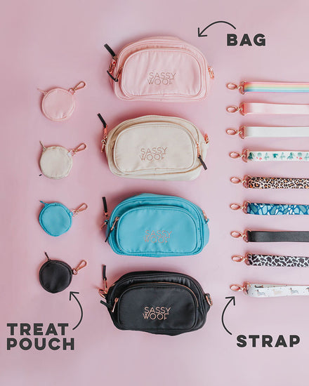An example of the build-your-own crossbody. 4 treat pouches in the colors pastel pink, cream, pastel blue, and black (all with gold-toned clasps) line a flat service on the left side. In the middle, there are four crossbody bag pouches all the same colors as the matching treat pouches, then on the right side is 9 different varieties of straps which are as follows: sassy stripes (pastel rainbow), pastel pink, cream, cactus print, leopard print, blue desert floor, black, cow print, and dauschund print.
