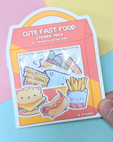 Four kawaii fast food holographic sparkle vinyl stickers.  Featuring a cat hamburger, kitty hot dog, kitten french fries, and milkshake.  From independent designer Tawnyillustrations.