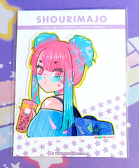 A pink and blue gradient haired girl w/2 buns on her head.  She has pink eyes & blue translucent heart shaped glasses.  She is wearing a blue striped off the shoulder shirt & a dark blue polka dot backpack with a star on it.  She is holding a pink boba tea drink that has a pink straw & a kitty cat printed on the outside of the cup.  She also has a white heart on her shoulder.  All of this kawaii manga digital art illustration is printed with a white border on a broken glass holographic vinyl sticker.