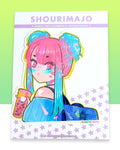 A pink and blue gradient haired girl w/2 buns on her head. She has pink eyes & blue translucent heart shaped glasses. She is wearing a blue striped off the shoulder shirt & a dark blue polka dot backpack with a star on it. She is holding a pink boba tea drink that has a pink straw & a kitty cat printed on the outside of the cup. She also has a white heart on her shoulder. All of this kawaii manga digital art illustration is printed with a white border on a broken glass holographic vinyl sticker.