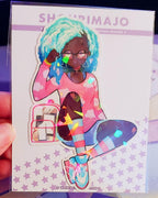 An african american girl with blue ombre hair, glasses, and purple eyes.  She has heart dangle earrings, and a pink cloud ombre long sleeve tshirt.  She has a pink and clear backpack with handheld gaming consoles inside.  She is also wearing light blue and pink striped socks and blue and pink cross traines.  She has three bracelets and her hand is by her head.  She is in a sitting position.  All of this kawaii manga digital art is printed on a broken glass holographic vinyl sticker with a white border.
