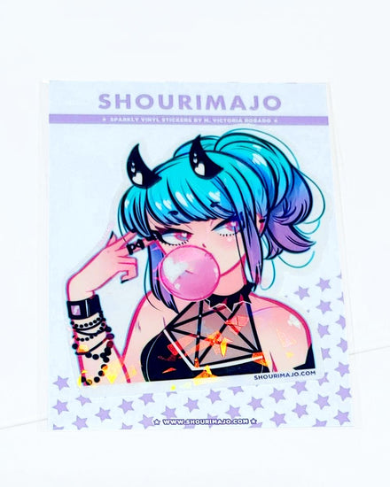 A hot cutie with blue and purple ombre hair, black horns with white hearts wearing black beaded bracelets and a black halter top with five point occult star straps at her chest.  She is pointing at her temple with two fingers and blowing a bubble with her bubble gum.  Her eyes are blue and pink.  The manga kawaii drawing is printed on a broken glass holographic vinyl sticker. 