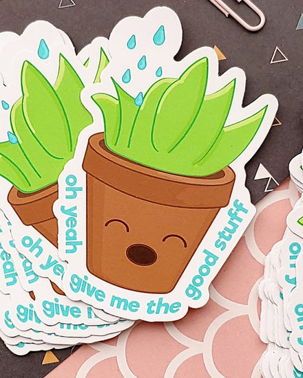 A kawaii matte vinyl sticker featuring a potted plant wanting the "good stuff." In other words, water! This is a green, brown, blue, and white succulent plant enjoying what it's getting. It reads "oh yeah give me the good stuff"