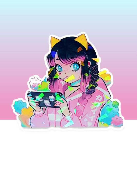 A cute kawaii manga teen gamer girl wearing a pink and white hoodie with a sucker in her mouth and yellow cat ears on her head is seen in front of cotton candy clouds of pink, yellow, blue, and green while playing on her nintendo switch with blue joy cons.  The switch has cute kitty stickers on the back.  This image is printed on broken glass holographic vinyl and is 3 inches long.