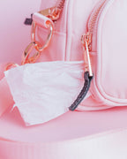 The pastel pink bag that goes with the build-your-own crossbody features gold-toned zippers and details w/black weaved zipper tags.  This photo shows how you can use the two compartmented bag as a waste bag holder if you do not wish to buy one separately.