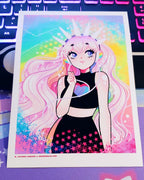A girl with rainbow headphones and pink hair looks off to the side and has her hand up towards her face.  She is wearing a black cropped top with a heart and has purple eyes.  The background behind her is gradient rainbow.  She has a white crown on her head.  All of this digital art piece is printed on high quality photo paper.